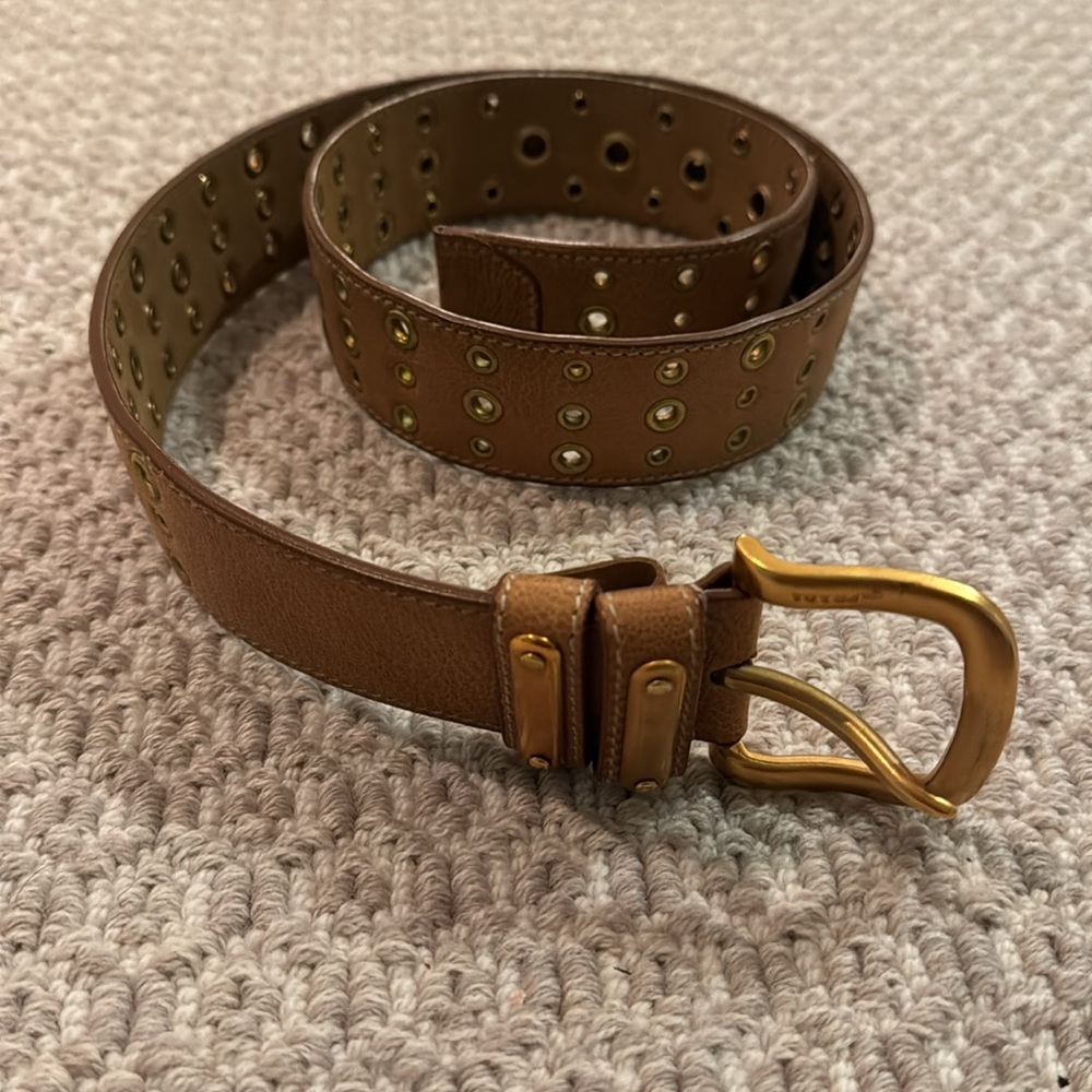 Gorgeous tan/caramel Prada belt with gold grommets and buckle. Worn lightly.